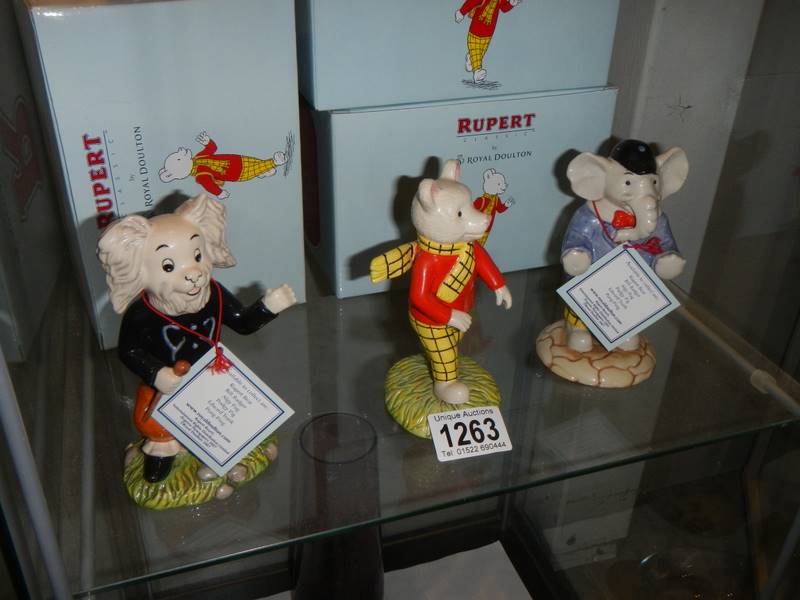 Three boxed Royal Doulton Rupert figures.