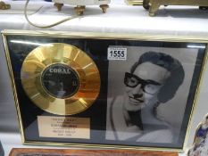 A framed and glazed Buddy Holly "Peggy Sue" gold disc.