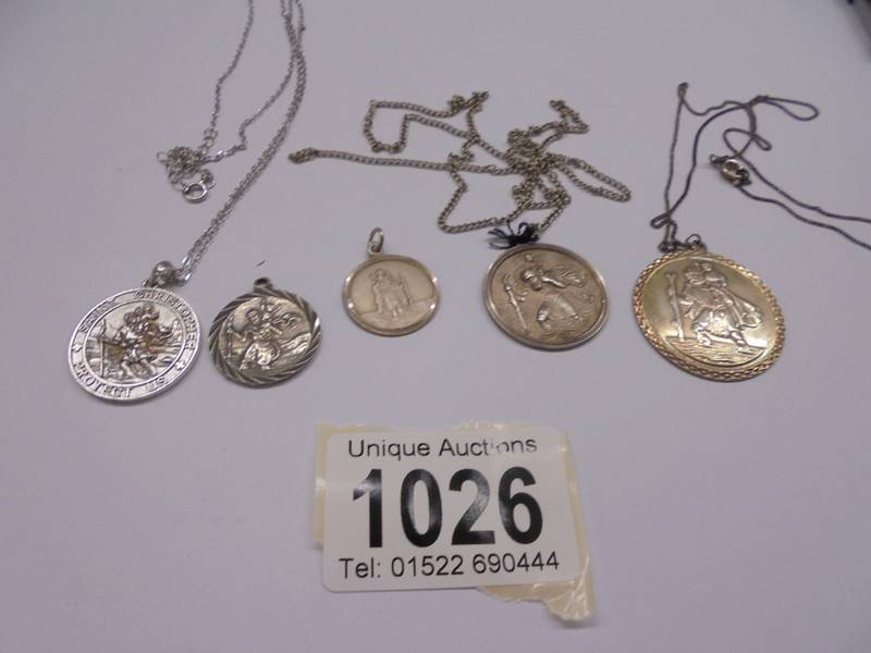 Five silver St. Christopher pendants, 26 grams.