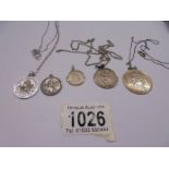 Five silver St. Christopher pendants, 26 grams.