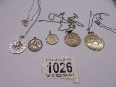 Five silver St. Christopher pendants, 26 grams.