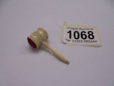 A miniature auctioneer's gavel,