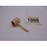 A miniature auctioneer's gavel,