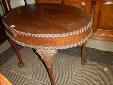 An oval mahogany table on ball and claw feet. COLLECT ONLY.