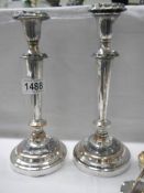 A pair of silver plate candlesticks.