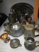 A mixed lot of pewter tankards etc.,