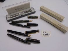 Four fountain pens including Osmiroid, Shaeffer etc., a Parker pen and two Parker pen boxes.