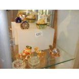 Three jewelled camel trinket boxes, a rabbit trinket box and a scent bottle.