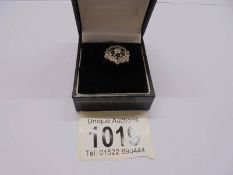 A 9ct gold cluster ring in a floral shape, size L.