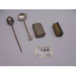 A silver monogrammed vesta case, a silver moustache brush, a small silver ladle and another spoon,