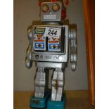 A vintage Japanese tin plate battery operated robot (working when tested).