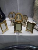 A collection of early to mid 20th century photo frames including brass examples.