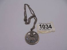 A silver St. Christopher with attached silver chain, 15 grams.