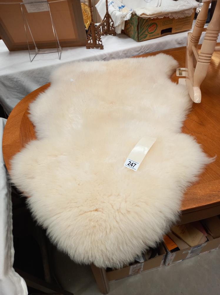 A sheepskin rug 94cm x 60cm at widest parts