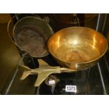 A brass jam pan, a brass bowl and a brass airplane.