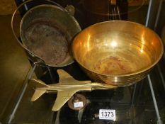 A brass jam pan, a brass bowl and a brass airplane.