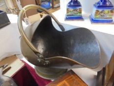 A brass helmet shaped coal scuttle, COLLECT ONLY.