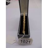 A 9ct gold twist design bangle, 4.3 grams.