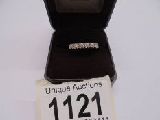 An 18ct white gold ring set seven diamonds, size F half, 3.5 grams.
