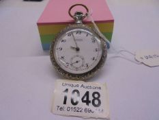 An old pocket watch in a case featuring a Blacksmith shop marked H Girard Besancon.