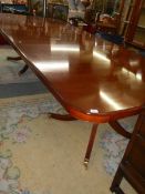 AN extending mahogany double pedestal dining table on splay feet, 305 cm long, COLLECT ONLY.