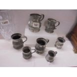 A set of seven graduated pewter measures.