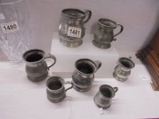 A set of seven graduated pewter measures.