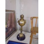 A brass oil lamp with drop in font and complete with chimney, COLLECT ONLY.