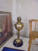 A brass oil lamp with drop in font and complete with chimney, COLLECT ONLY.