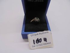 A green/white stone ring dated Birmingham 1994 in 9ct gold, sixe L half, 1.9 grams.