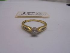 An 18ct gold ring with centre diamond, size O, 2.7 grams.