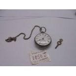 A silver pocket watch on a white metal chain.