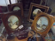 Four framed ceramic pictorial plaques.