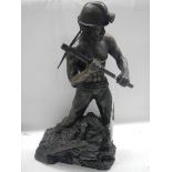 A heavy metal figure of a miner,