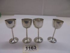 Four miniature silver goblets, (German 800).