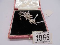 An exquisite 18ct white gold and diamond floral spray brooch.