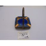 A copper and enamel ashtray stand with four ashtrays.