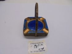 A copper and enamel ashtray stand with four ashtrays.