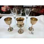 A pair of tall air twist stem glasses and 3 silver plated goblets