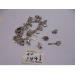 A silver charm bracelet with padlock and 22 charms (2 marked 925, others not marked) and 4 charms.