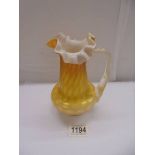 An antique yellow satin galss jug, 16 cm tall.