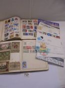 Two albums of world stamps and a quantity of first-day covers.