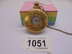 A gold plated half hunter pocket watch on chain, in working order.
