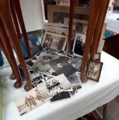A quantity of old black and white photos, some of which have postcard backs