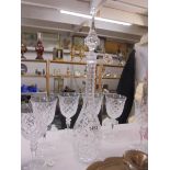 A tall elegant cut glass decanter with six glasses. COLLECT ONLY.