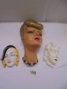 Two ceramic art deco lady wall masks and a plaster wall mask.