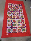 A patchwork reversible cot quilt.