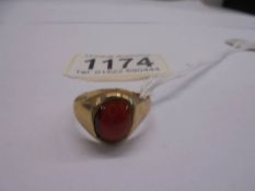 A 9ct gold ring set large red stone, size Q, 2.5 grams, (has split in gold).