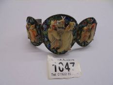 An old Chinese bangle featuring Chinese figures.
