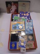 A quantity of coins, mostly crowns including £5 coins and presentation sets.